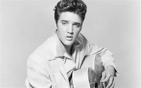 Download Elvis Presley With His Guitar Wallpaper | Wallpapers.com