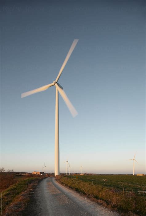 Country Dirt Road With Huge Windmills By Stocksy Contributor Miquel