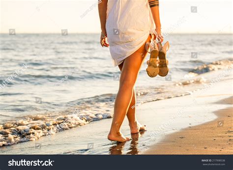 Woman Walking Alone On Beach Stock Photo 217998538 | Shutterstock