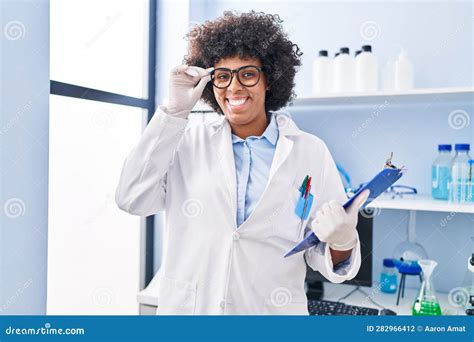 African American Woman Scientist Smiling Confident Holding Clipboard At