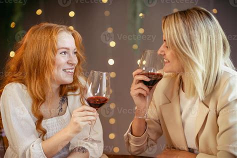 Lesbian Couple Having Dinner In A Restaurant Girls Drink Wine And Talk