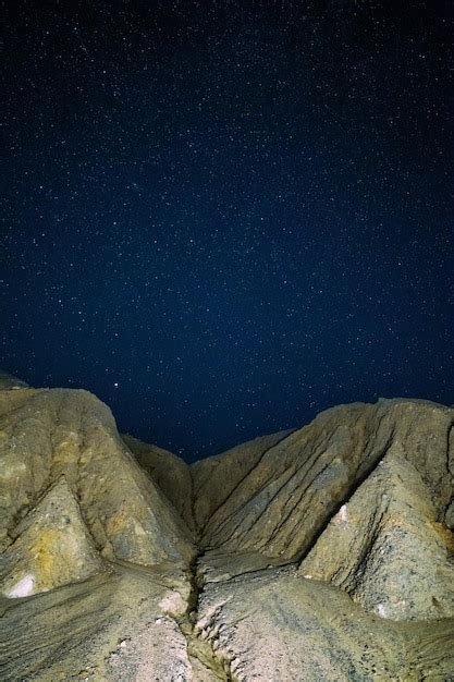 Premium Photo Night Sedimental Mountains At Starry Night