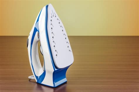 Premium Photo Electric Steam Iron On The Wooden Table 3d Rendering