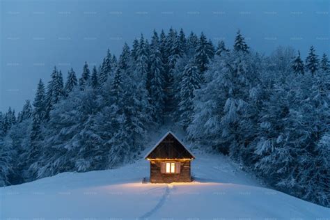 Glowing Wooden Cabin In Snowy Forest - Stock Photos | Motion Array