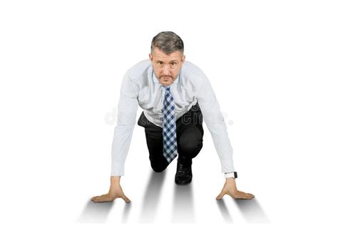 Businessman In Ready To Run Position Isolated Over White Background