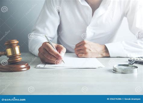 Judge Writing On Paper At Table In Courtroom Stock Photo Image Of