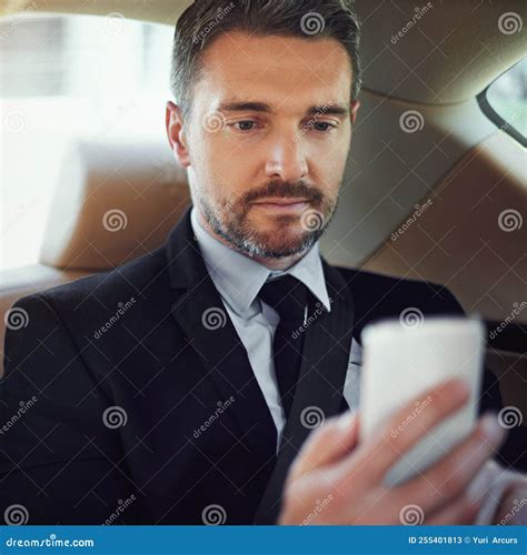 Doing Business on the Go. a Businessman Using His Cellphone while