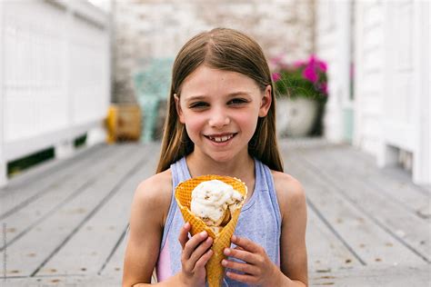 "Treat: Young Girl Holds Waffle Cone With Ice Cream" by Stocksy ...