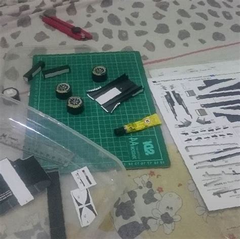 Some Tools Are Laying Out On A Table With Paper And Other Crafting