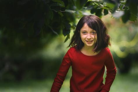 Premium Photo Portrait Of Smiling Girl Standing Outdoors