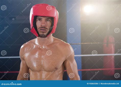 Portrait Of Shirtless Male Boxer Wearing Red Headgear Stock Photo