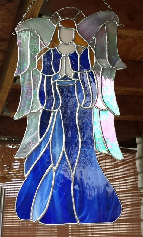 A Stained Glass Angel Hanging From The Ceiling