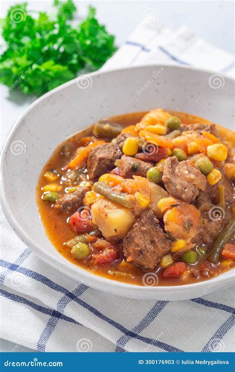 Beef Stew With Potato Green Beans Carrot Peas And Corn In Gray Bowl