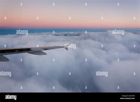 Sunset viewed from airplane above clouds Stock Photo - Alamy