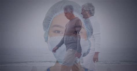 Senior Couple Waking On The Beach Against Portrait Of Asian Female