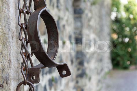 Medieval prison chains for prisoners in front of stone wall | Stock image | Colourbox