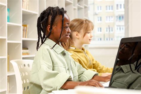 Premium Photo African American Boy Playing Computer With Friend