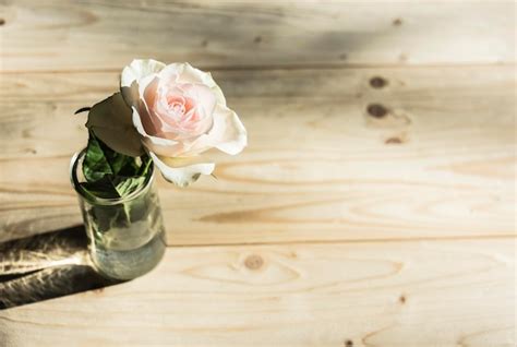 Premium Photo High Angle View Of Rose In Glass On Table