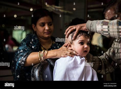 Kid crying having his first haircut. Varanasi, India Stock Photo - Alamy