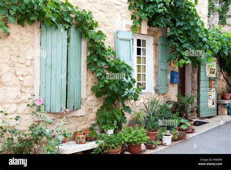 Street scene with many plants in pots in a small town in provence ...