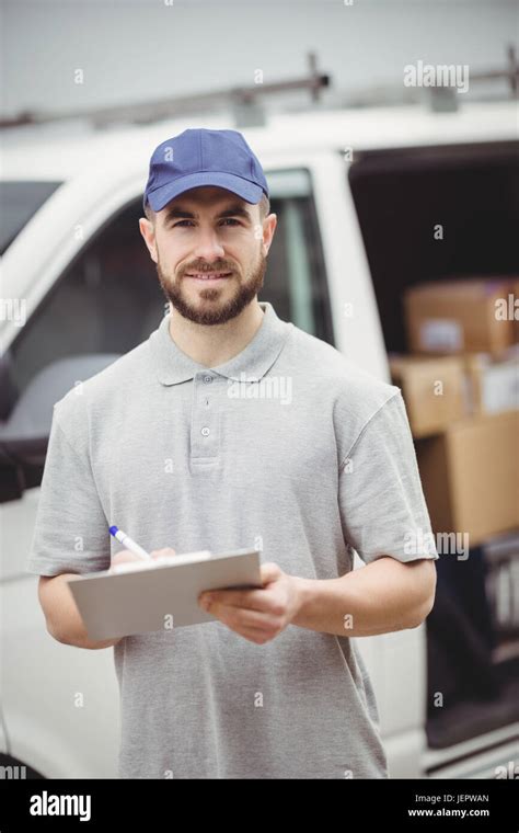 Delivery Man Writing On Clipboard Stock Photo Alamy