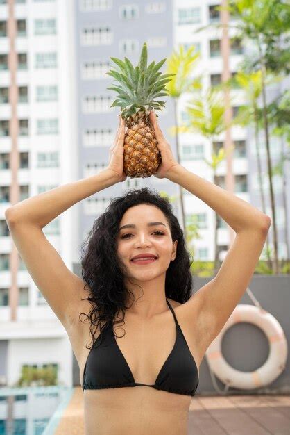 Bikini mujer joven mostrando piña Piña fruta mujer sonriendo saludable