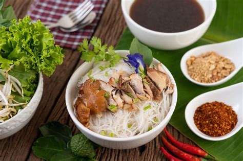 Chicken Noodle In A Bowl With Side Dishes Thai Food Stock Photo