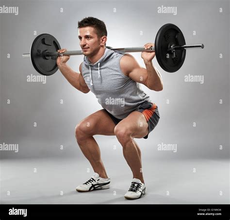 Man Doing Squats With Barbell On Neck Back Studio Shot Stock Photo Alamy