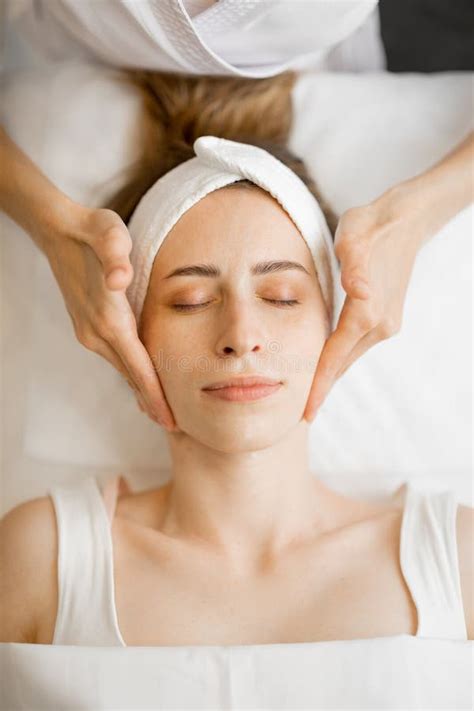 Beautician Makes A Face Massage For A Woman Stock Photo Image Of