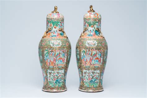 A Pair Of Chinese Baluster Shaped Canton Famille Rose Vases With Palace