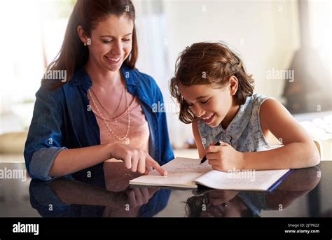 Et ce qu est ce mot ici Une mère aidant sa fille avec ses devoirs