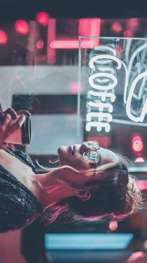 A Woman Laying On The Floor With Her Phone To Her Ear While Holding A Glass