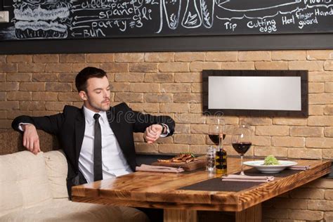 Young Man Sitting In Cafe Waiting For Somebody Stock Image Image Of