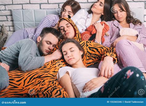 Sleeping Group of Young People on the Bed. Stock Photo - Image of ...