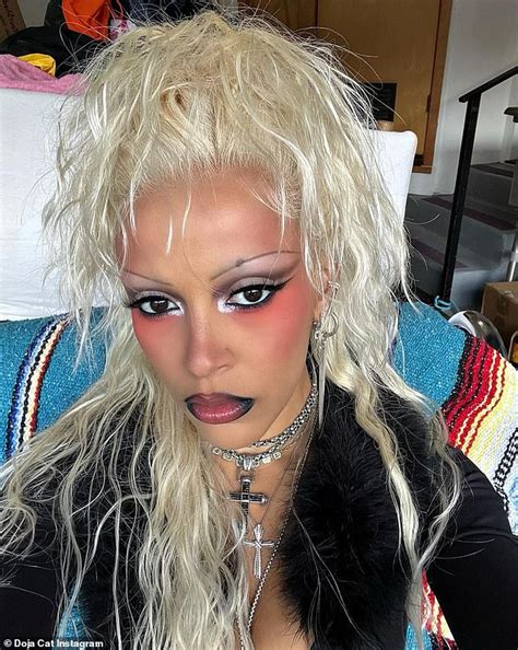 Doja Cat Puts On A VERY Busty Display Donning A Black Cutout Bodysuit And Platinum Blonde Wig