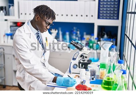 African American Man Scientist Using Microscope Stock Photo 2214290019