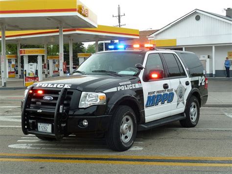 A Police Car Parked In Front Of A Gas Station