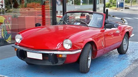 Premium Photo Red Vintage Car Parked On Road