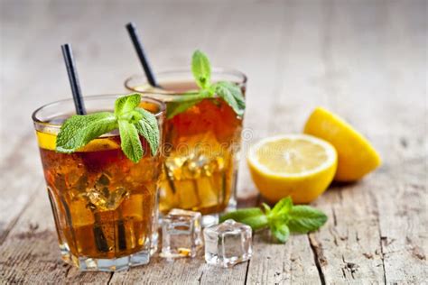 Traditional Iced Tea With Lemon Mint Leaves And Ice Cubes In Glasses