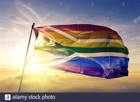 Gay Pride Of South Africa Flag Waving On The Top Sunrise Mist Fog Stock