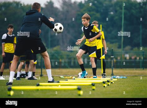 Teenagers on soccer training camp. Boys practice football with young ...