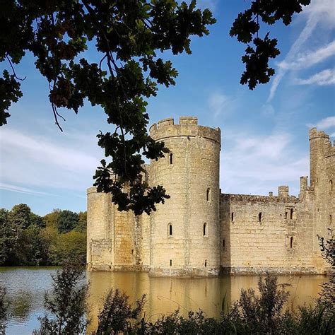 An Old Castle Sitting Next To A Body Of Water