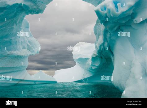 Arched Iceberg Floating Off The Western Antarctic Peninsula Antarctica