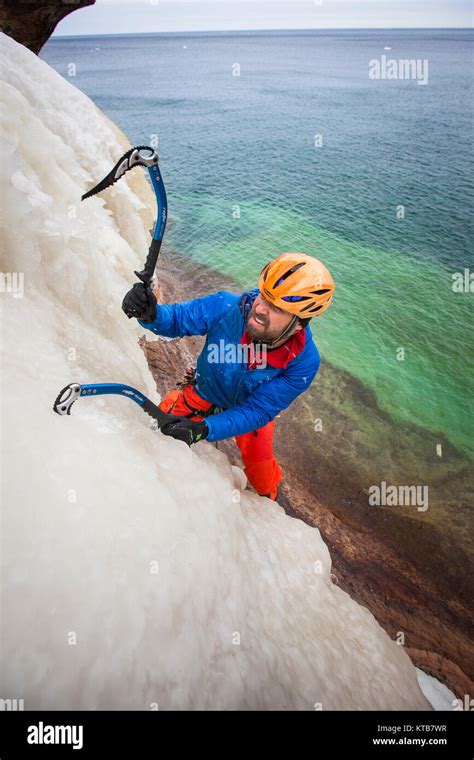 An ice climber in Northern Michigan, climbing at Pictured Rocks ...