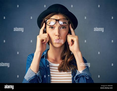 Are you brave enough to be weird. Portrait of a quirky young woman smiling against a gray ...