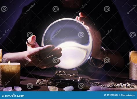 Soothsayer Using Crystal Ball To Predict Future At Table In Darkness