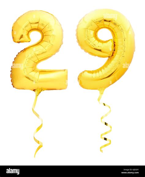 Golden number 29 twenty nine made of inflatable balloon with golden ribbon isolated on white ...