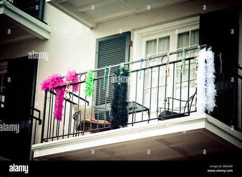 Mardi Gras beads decorate a balcony on Bourbon Street in New Orleans ...