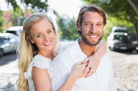 Premium Photo Attractive Couple Hugging Each Other And Smiling At Camera