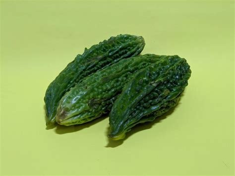 Premium Photo Three Bitter Gourd Vegetables On Yellow Background